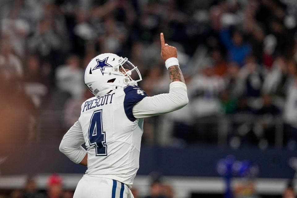 Dallas Cowboys quarterback Dak Prescott reacts after throwing a touchdown against the Philadelphia Eagles during the first half of an NFL football game, Sunday, Dec. 10, 2023, in Arlington, Texas.