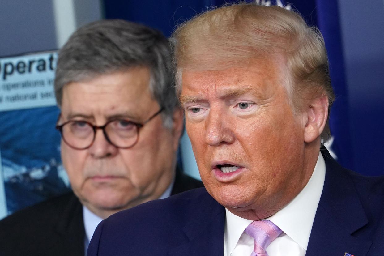 President Donald Trump speaks, flanked by Attorney General William Barr (left), during the daily briefing on the novel coronavirus on April 1. (Photo: MANDEL NGAN via Getty Images)