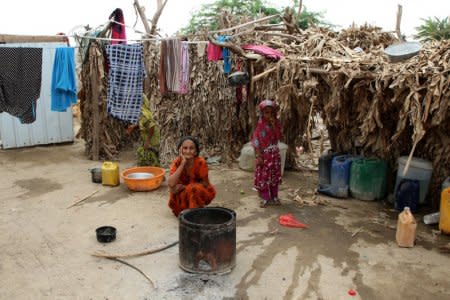 A woman displaced by the fighting in the Red Sea port city of Hodeidah sits near her hut at a camp for IDPs near Aden, Yemen June 23, 2018. REUTERS/Fawaz Salman