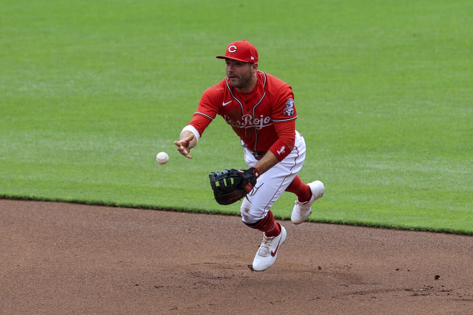 Cincinnati Reds' Joey Votto fields the ball and throws to first base during the first inning of a baseball game against the Chicago White Sox in Cincinnati, Wednesday, May 5, 2021. (AP Photo/Aaron Doster)