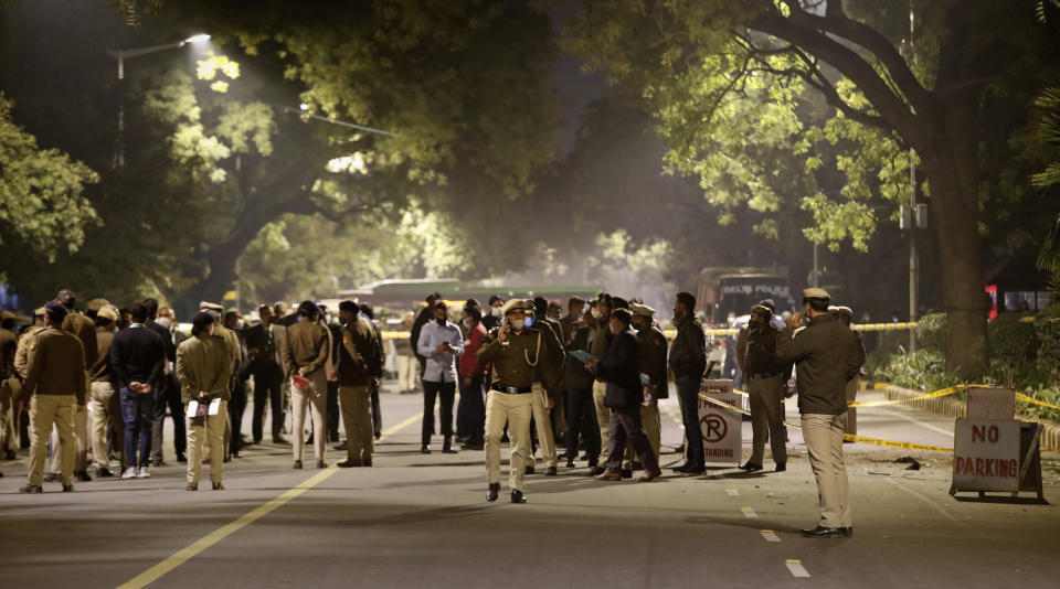 Policemen stand guard near the Israeli Embassy after a blast in the area in New Delhi, India, Friday, Jan. 29, 2021. A "very low intensity" device exploded Friday near the Israeli Embassy in the Indian capital, but there were no injuries and little damage, police said. (AP Photo/Manish Swarup)