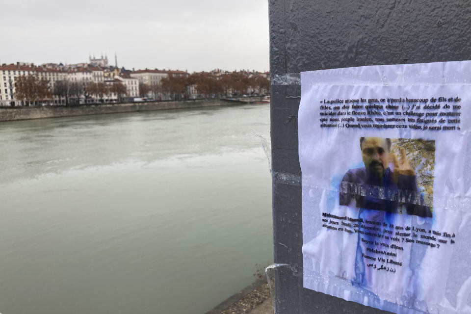 A picture of Mohammad Moradi, an Iranian activist who took his own life after jumping in the Rhone river in the French city of Lyon, is on display as part of a tribute, Friday, Dec. 30, 2022. When a 38-year-old man anguished over the protests in Iran took his own life in the French city of Lyon, fellow members of the Iranian diaspora felt his pain. Three months into the anti-government protests that have swept Iran, Iranians abroad are going through a spectrum of emotions. (AP Photo/Nicolas Vaux-Montagny)