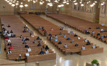 FILE - In this Sunday, June 7, 2020, file photo, a hundred faithful sit while minding social distancing, listening to Los Angeles Archbishop Jose H. Gomez celebrate Mass at Cathedral of Our Lady of the Angels, the first Mass held in English at the site since the re-opening of churches, in downtown Los Angeles. Attendance at the Mass is limited to 100 people. California Gov. Gavin Newsom on Monday, July 13, 2020, extended the closure of bars and indoor dining statewide and ordered gyms, churches and hair salons closed in most places as coronavirus cases keep rising in the nation's most populated state. Newsom has compared his strategy of opening and closing businesses as a "dimmer switch," highlighting the flexibility needed as public health officials monitor the virus's progress. (AP Photo/Damian Dovarganes, File)