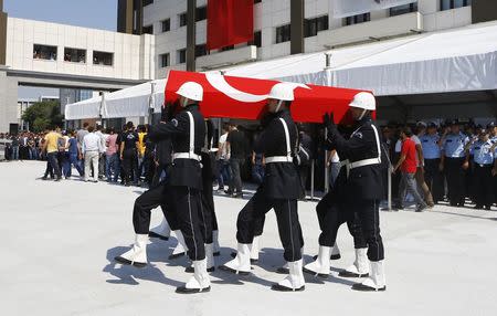 Coffin of police officer Muhammet Fatih Sivri is carried by his fellow officers during his funeral ceremony in Istanbul, Turkey, July 27, 2015. REUTERS/Osman Orsal