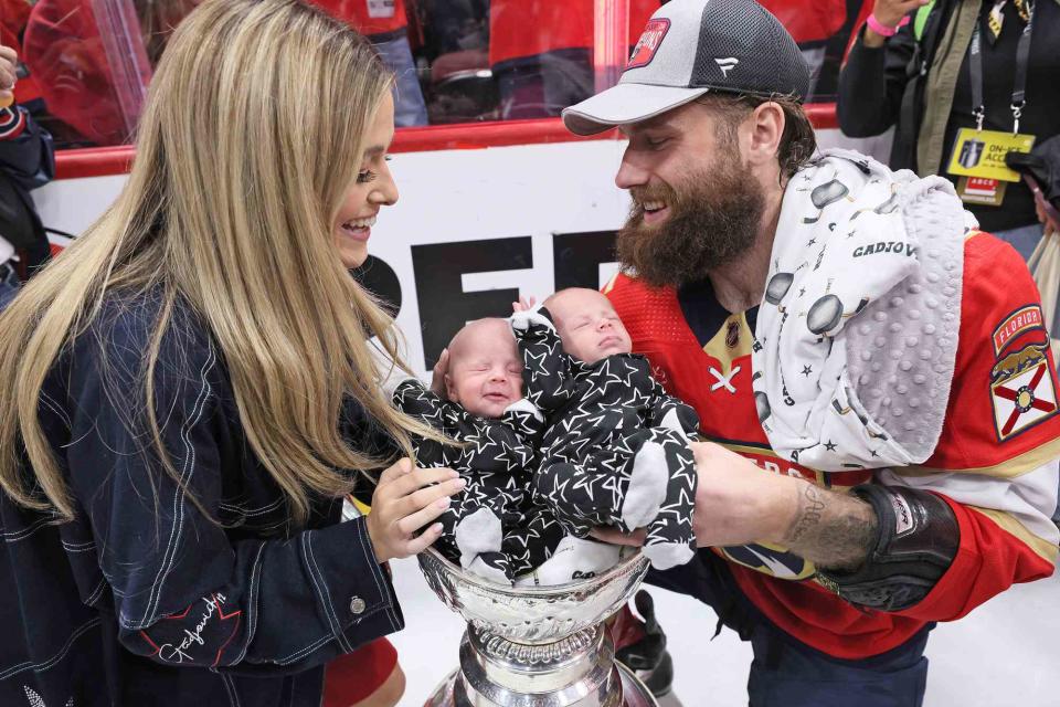 <p>Bruce Bennett/Getty</p> Jonah Gadjovich of the Florida Panthers and his twins inside the Stanley Cup