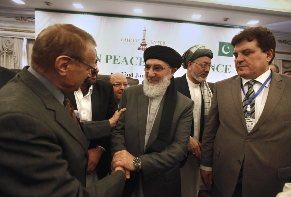 Afghan Warlord Gulbuddin Hekmatyar, leader of Islamist organization Hezb-i-Islami, center, shakes hand with a paticipant after the opening session of Afghan Peace Conference in Bhurban, 65 kilometers (40 miles) north of Islamabad, Pakistan, Saturday, June 22, 2019. Dozens of Afghan political leaders attended a peace conference in neighboring Pakistan on Saturday to pave the way for further Afghan-to-Afghan dialogue. (AP Photo/Anjum Naveed)