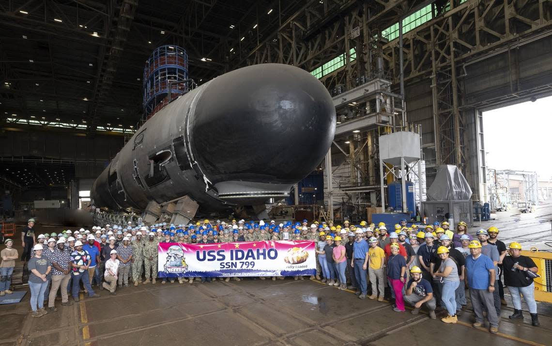 The USS Idaho crew and Electric Boat employees pose for a photo with the future USS Idaho SSN 799 in October. The USS Idaho is four stories tall, four stories wide and 377 feet long. The nuclear submarine is scheduled to be christened March 16 in Groton, Connecticut.