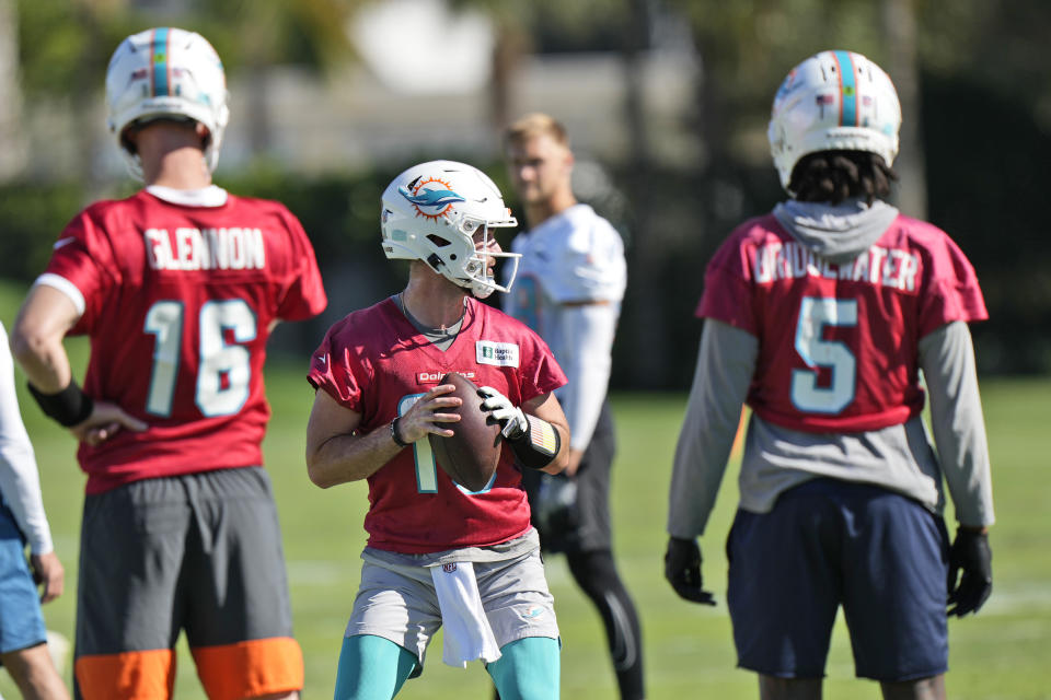 Miami Dolphins quarterback Skylar Thompson, center, runs a drill as Teddy Bridgewater (5) and practice squad quarterback Mike Glennon (16) look on during practice at the NFL football team's practice facility, Wednesday, Jan. 11, 2023, in Miami Gardens, Fla. The Dolphins will play the Buffalo Bills in a wild-card game on Sunday. (AP Photo/Wilfredo Lee)