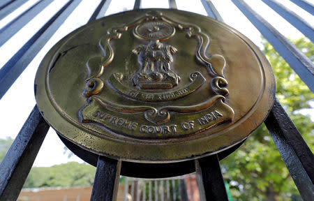 FILE PHOTO: The emblem of the Supreme Court is seen on a gate of the court in New Delhi, India, September 28, 2018. REUTERS/Anushree Fadnavis/File Photo