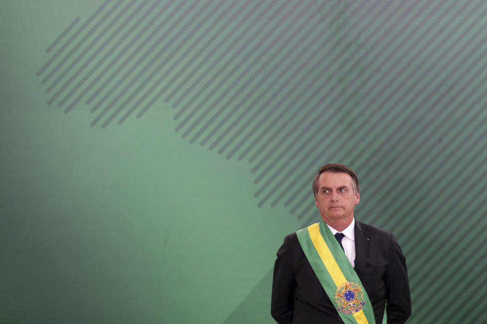 FILE - In this Jan. 1, 2019, file photo, Brazil's President Jair Bolsonaro looks on as he presents his cabinet at the Planalto Presidential palace, in Brasilia, Brazil. The far-right leader’s first two weeks on the job have been filled with missteps and communication gaffes and little of his promised sweeping changes, underscoring a steep learning curve for a president elected on promises to overhaul much of daily life in Latin America's largest nation. (AP Photo/Eraldo Peres, File)