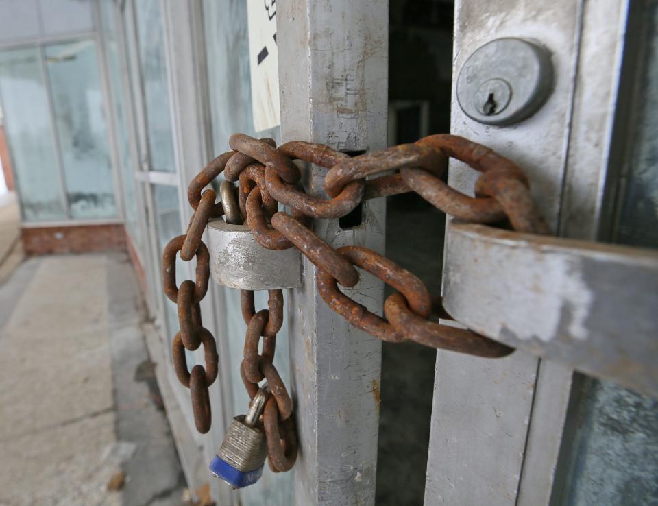 Chains secure one set of doors for the former High Point Furniture Store at the Midway Plaza on Wednesday in Tallmadge.