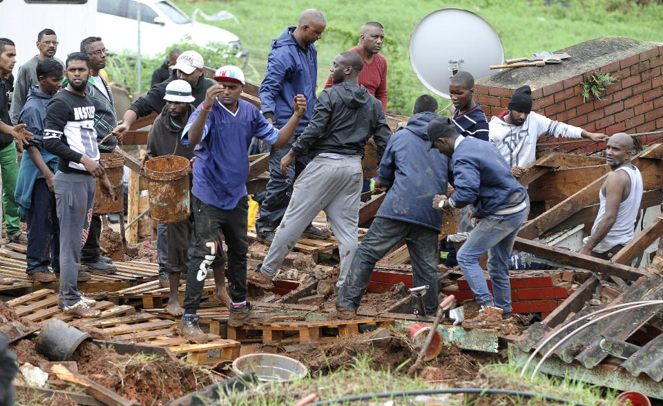 Rescue workers search for victims in a collapsed building near Durban, South Africa, Tuesday, April 23, 2019. South African media report that 33 people are dead from flooding and mudslides in the country's eastern KwaZulu-Natal province caused by heavy rains that began on Monday. (AP Photo)