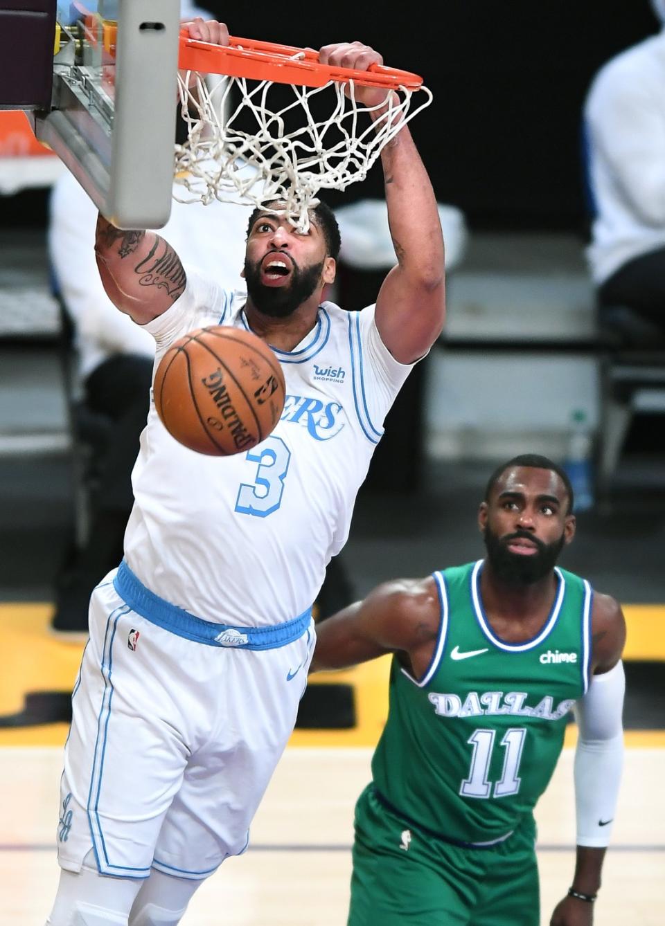 Lakers forward Anthony Davis dunks over Dallas Mavericks guard Tim Hardaway Jr. in the second quarter.