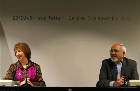 Iranian Foreign Minister Mohammad Javad Zarif (R) smiles next to European Union foreign policy chief Catherine Ashton during a news conference after nuclear talks at the United Nations European headquarters in Geneva November 10, 2013. REUTERS/Denis Balibouse