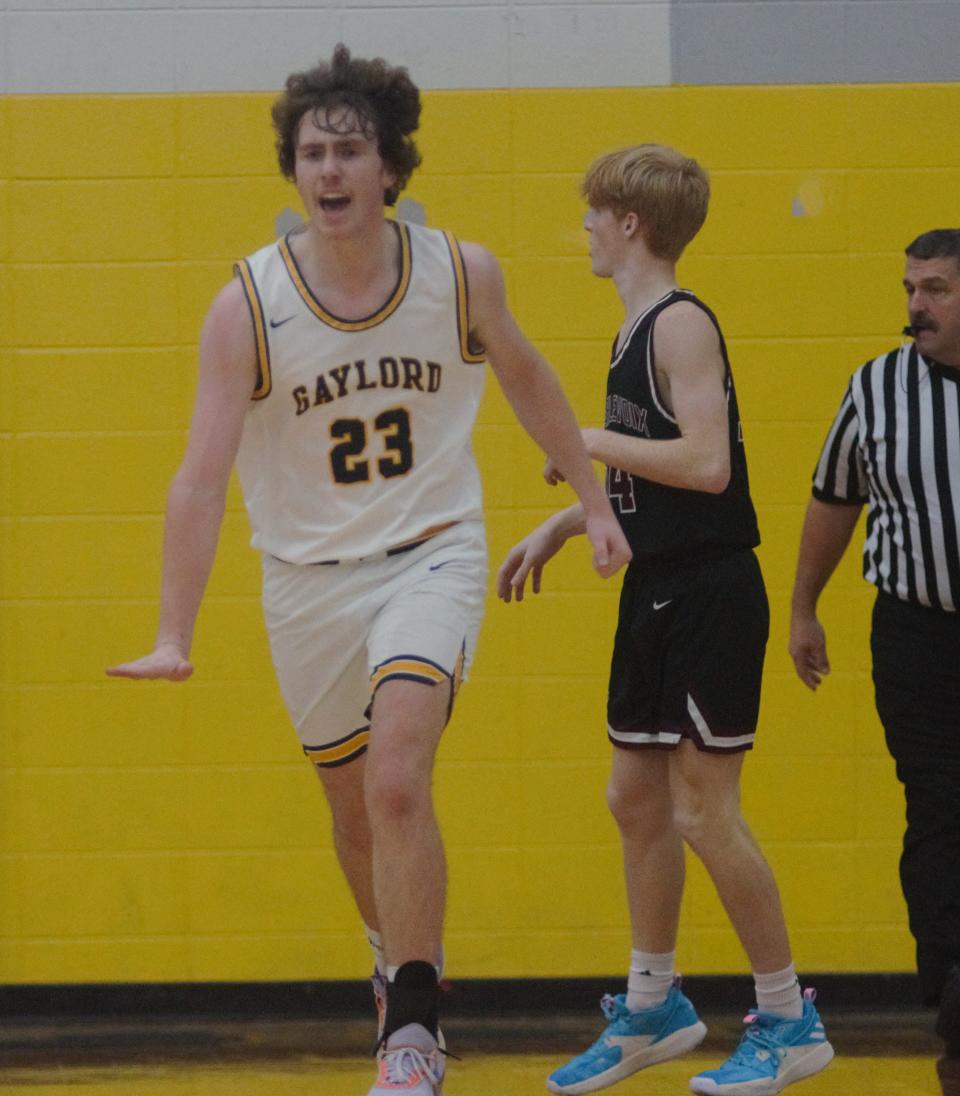 Luke Enders signals his defender is too small during a basketball matchup between Gaylord and Charlevoix on Tuesday, December 6 in Gaylord, Mich.