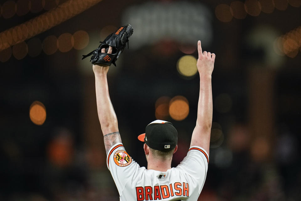 Baltimore Orioles starting pitcher Kyle Bradish reacts after teammate center fielder Cedric Mullins made a diving catch on a ball hit by Tampa Bay Rays' Taylor Walls in the second inning of a baseball game, Thursday, Sept. 14, 2023, in Baltimore. (AP Photo/Julio Cortez)