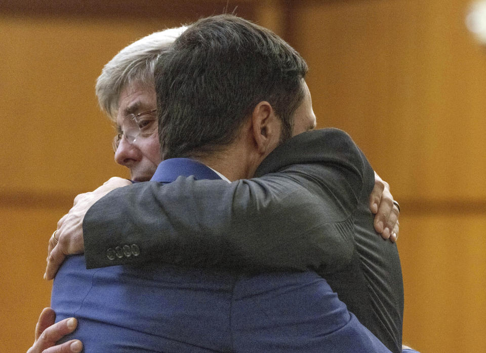 FILE - Tacoma police officer Christopher "Shane" Burbank, right, gets a hug from his attorney Wayne Fricke after he is declared not guilty for any charges related to the March 2020 killing of Manny Ellis, Dec. 21, 2023, in Pierce County Superior Court in Tacoma, Wash. Three Washington state police officers who were cleared of all criminal charges last month in the death of Ellis will each receive $500,000 to leave the Tacoma Police Department, according to documents released Tuesday, Jan. 16, 2024. (Ellen M. Banner/The Seattle Times via AP, Pool, File)