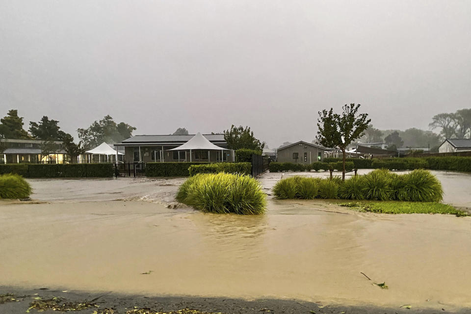 Water floods a street in Havelock North, southeast of Auckland, New Zealand, Tuesday, Feb. 14, 2023. The New Zealand government declared a state of emergency across the country's North Island, which has been battered by Cyclone Gabrielle. (Warren Buckland/Hawkes Bay Today via AP)