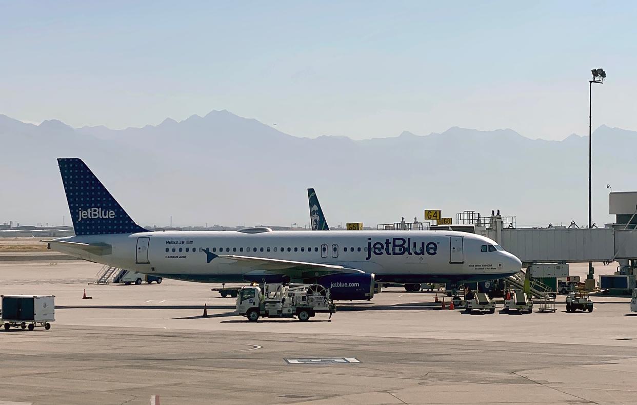 A JetBlue Airlines plane is seen at a gate at Salt Lake City International Airport on October 8, 2020.