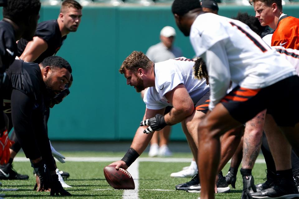 Cincinnati Bengals center Ted Karras (64) gets set to snap the ball to Cincinnati Bengals quarterback Joe Burrow (9) during organized team activities practice, Tuesday, June 14, 2022, at Paul Brown Stadium in Cincinnati.