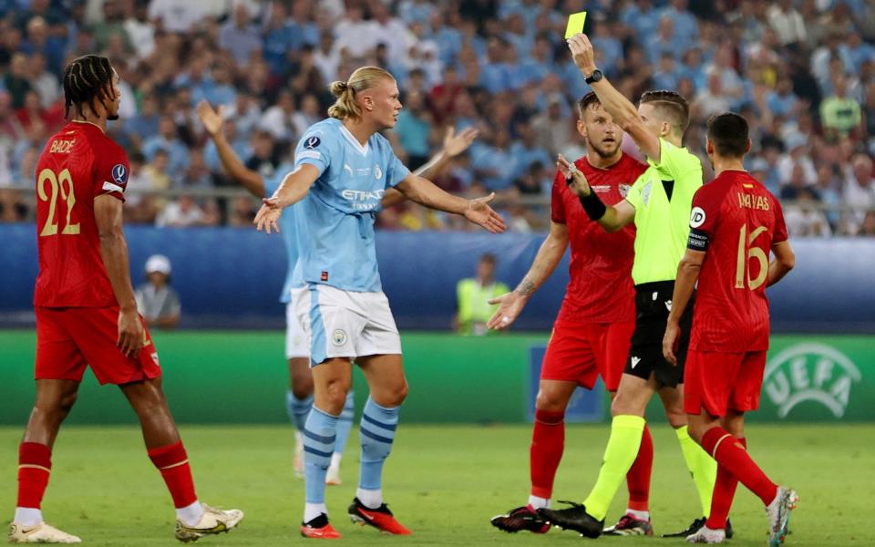 Sevilla's Loic Bade is shown a yellow card