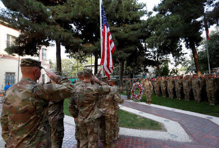 U.S. soldiers prepare to raise the American flag during a memorial ceremony to commemorate the 16th anniversary of the 9/11 attacks, in Kabul, Afghanistan September 11, 2017. REUTERS/Mohammad Ismail