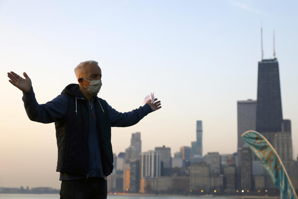 Park Community Church Pastor Joe Riccardi raises his hands as he prays during an Easter sunrise service on Sunday, April 4, 2021, at North Avenue Beach in Chicago. (AP Photo/Shafkat Anowar)