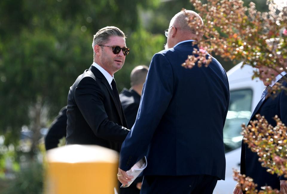 Former Australian cricketers Michael Clarke (pictured left) and Merv Hughes (pictured right) chat as they arrive for a private memorial service for Australian cricket superstar Shane Warne.