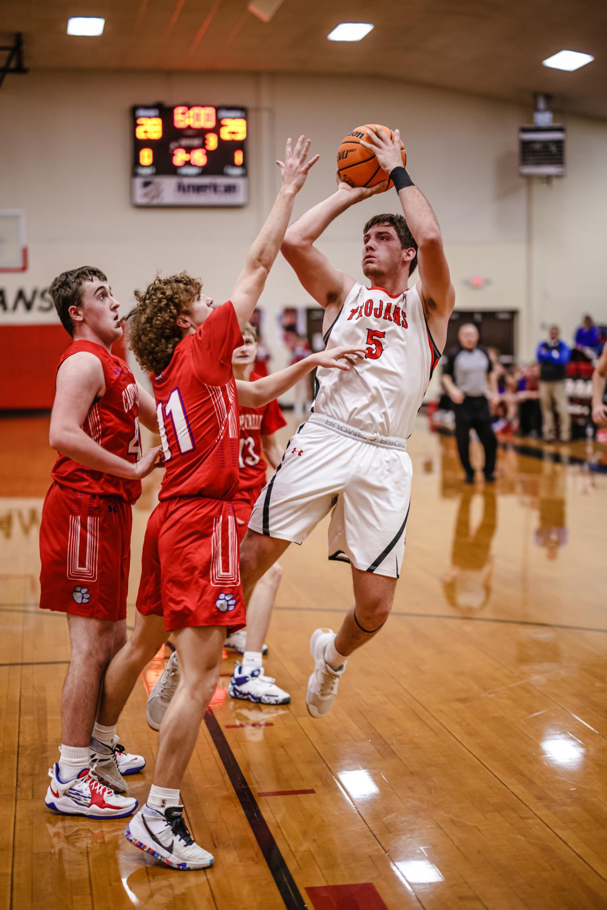 Caney Valley's Daniel Barham makes a pull up jumper over Caney Valley Kansas' Jack Billingsley during Thursday night's game.