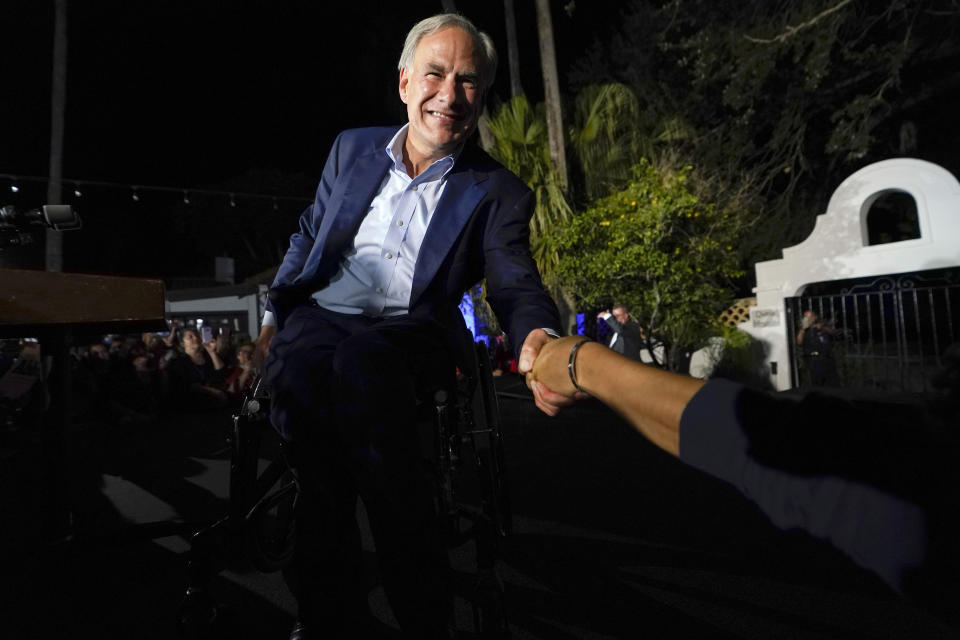 FILE - Texas Gov. Greg Abbott shakes hands with a supporter as he arrives to speak during an election night campaign event, Nov. 8, 2022, in McAllen, Texas. This week, Texas and other border states were preparing for the end of a policy that allowed the government to quickly expel migrants to Mexico. Abbott has deployed more Texas National Guard troops in response to the end of the rule. The goal, Abbott said this week: to “secure the Texas border.” (AP Photo/David J. Phillip, File)