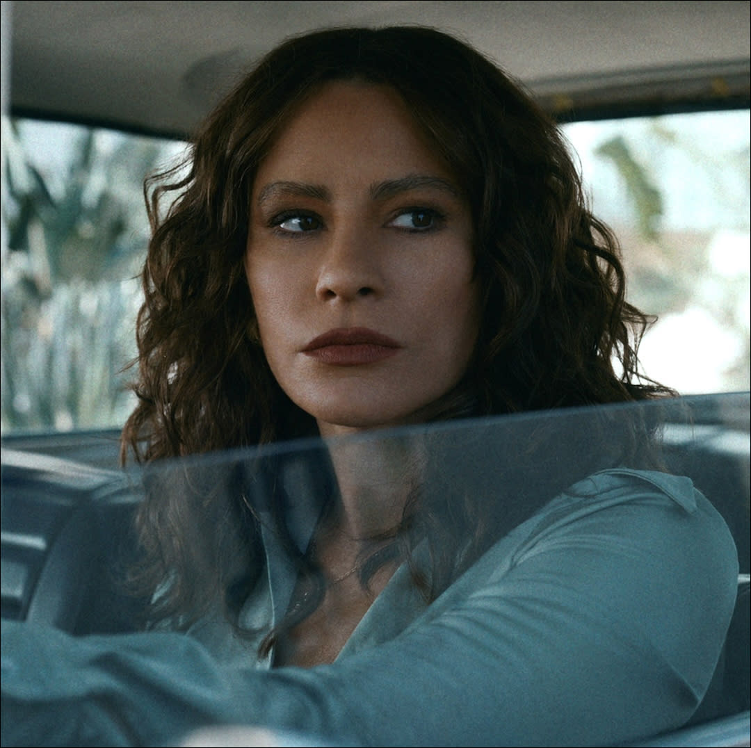  A woman (sofia vergara as griselda) looks out of a car window. 