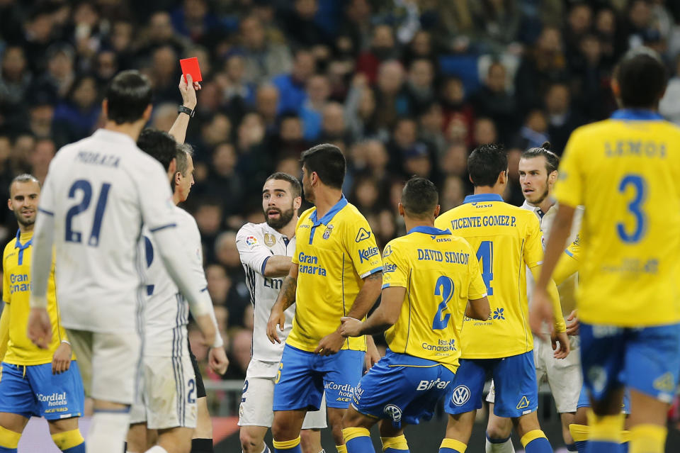 The referee shows a red card to Real Madrid's Gareth Bale, 2nd right, during a Spanish La Liga soccer match between Real Madrid and Las Palmas at the Santiago Bernabeu stadium in Madrid, Spain, Wednesday March 1, 2017. (AP Photo/Paul White)