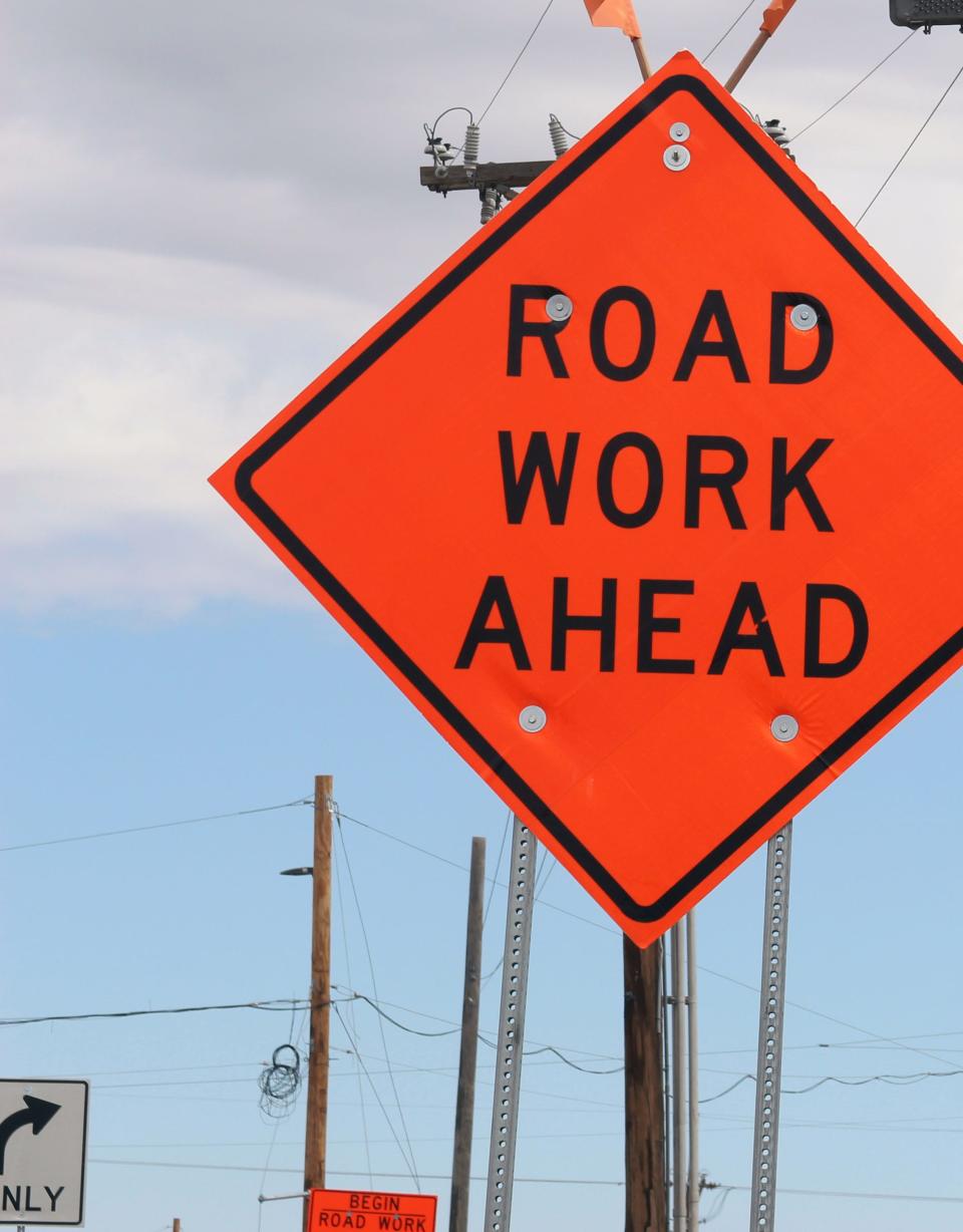 A construction sign notes road work underway .