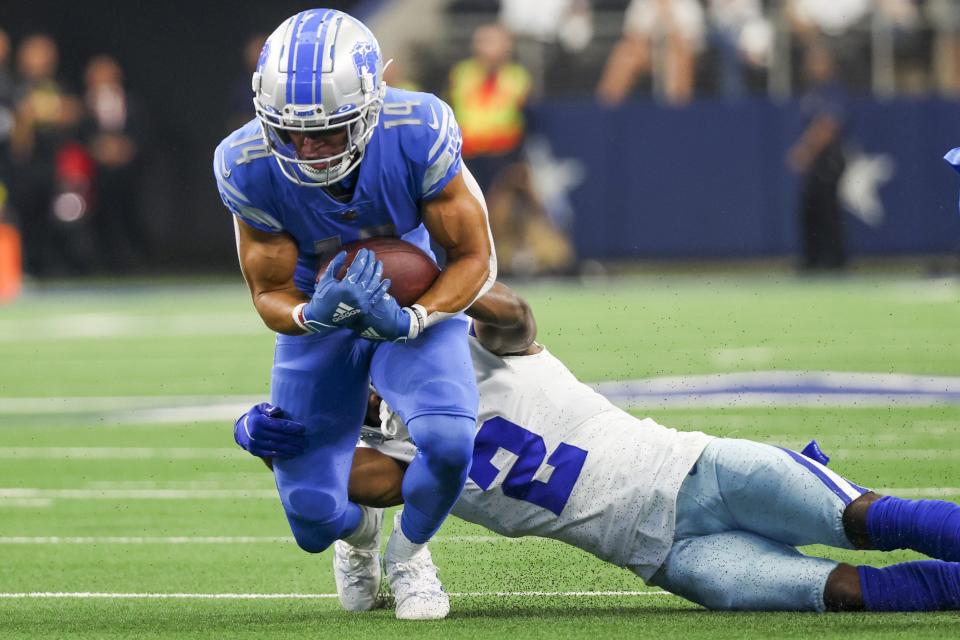 Lions wide receiver Amon-Ra St. Brown runs with the ball while being tackled by Cowboys cornerback Jourdan Lewis during the first half of the Lions' 24-6 loss on Sunday, Oct. 23, 2022, in Arlington, Texas.