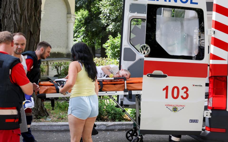 A boy is carried into an ambulance following a Russian attack on Kyiv's Ohmatdyt Children's Hospital