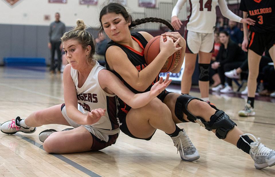 Westborough High School senior captain Kate Sams, left, and Marlborough senior Rose King wrestle for the ball at Westbrough, Jan. 12, 2024. The Rangers defeated the Panthers, 68-53.