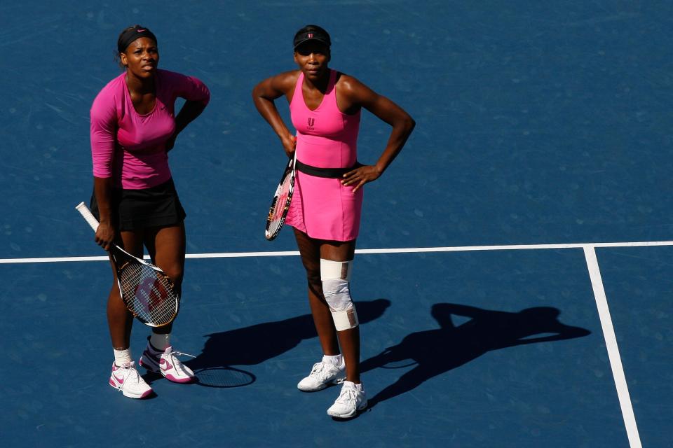 Serena (left) and Venus Williams compete in doubles at the 2009 US Open.