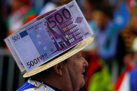 FILE PHOTO: A carnival reveller takes part in the "Rosenmontag" (Rose Monday) parade, the highlight of the annual carnival season in Cologne, Germany February 8, 2016. REUTERS/Wolfgang Rattay/File Photo