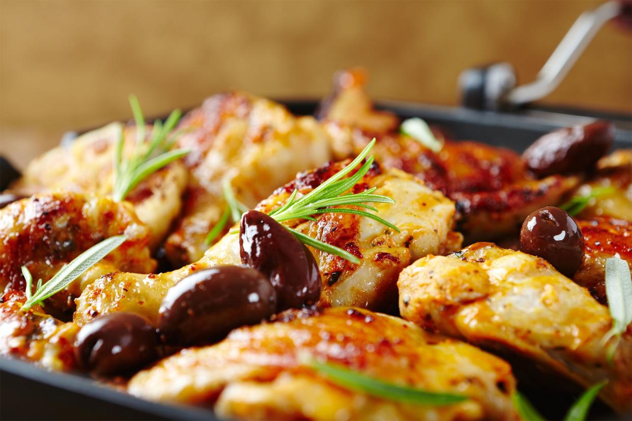 Closeup of Mediterranean chicken skillet with a blurred brown background