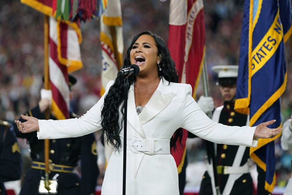 FILE - Demi Lovato performs the national anthem before the NFL Super Bowl 54 football game between the San Francisco 49ers and the Kansas City Chiefs in Miami Gardens, Fla., on Feb. 2, 2020. Lovato reveals publicly for the first time details about her near-fatal drug overdose in 2018 in “Demi Lovato: Dancing With the Devil,” a four-part docuseries debuting March 23, 2021, on YouTube Originals. (AP Photo/David J. Phillip, File)