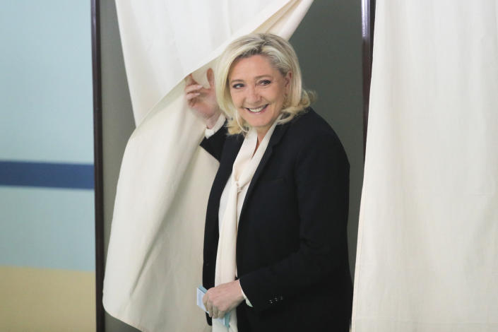 Marine Le Pen exits a voting booth.