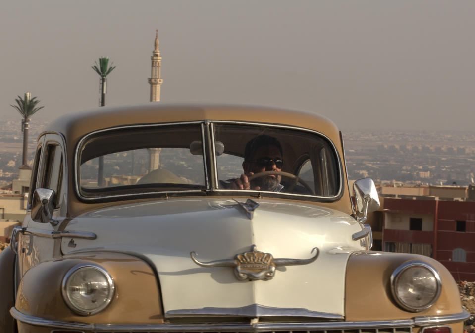 Egyptian collector Mohamed Wahdan drives a 1948 Chrysler in Obour city, near Cairo, Egypt, March 1, 2022. In more than 20 years, the 52 years-old businessman managed to collect a fleet of more than 250 vintage, antique and classic cars. (AP Photo/Amr Nabil)