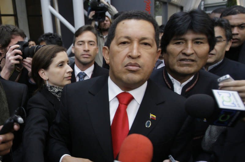 Venezuelan President Hugo Chavez talks to the media next to Bolivian President Evo Morales (R) as they arrive at a plenary session of the United Nations Climate Change Conference in Copenhagen, Denmark, on December 18, 2009. On March 5, 2013, Chavez died at age 58 and Vice President Nicolas Maduro ascends to the presidency. File Photo by Anatoli Zhdanov/UPI