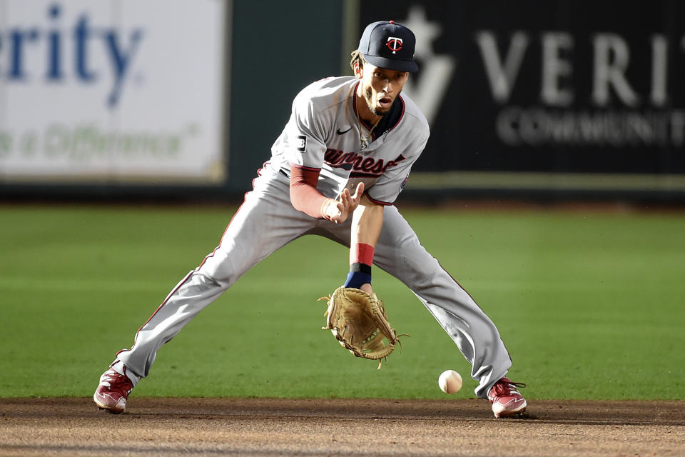 FILE - Minnesota Twins shortstop Andrelton Simmons fields a ground ball by Houston Astros' Carlos Correa during the first inning of a baseball game Aug. 7, 2021, in Houston. The Chicago Cubs agreed to a $4 million, one-year contract with Simmons, a person familiar with the situation said Friday, March 11, 2022. The person, confirming reports by The Athletic and MLB Network, spoke on the condition of anonymity because the deal hasn't been finalized. (AP Photo/Eric Christian Smith, File)