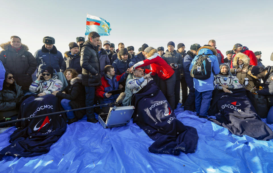 U.S. astronaut Christina Koch, left, Italian astronaut Luca Parmitano, right, and Russian cosmonaut Alexander Skvortsov sit in chairs shortly after the landing of the Russian Soyuz MS-13 space capsule about 150 km ( 80 miles) south-east of the Kazakh town of Zhezkazgan, Kazakhstan, Thursday, Feb. 6, 2020. A Soyuz space capsule with U.S. astronaut Christina Koch, Italian astronaut Luca Parmitano and Russian cosmonaut Alexander Skvortsov, returning from a mission to the International Space Station landed safely on Thursday on the steppes of Kazakhstan. (Sergei Ilnitsky/Pool Photo via AP)