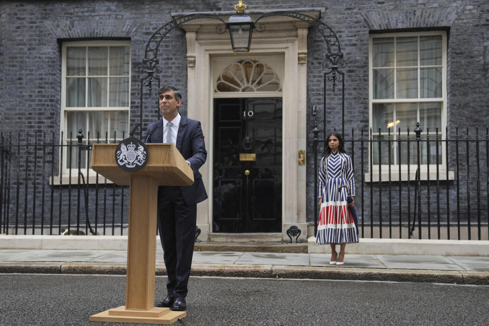 Britain's outgoing Conservative Party Prime Minister Rishi Sunak speaking outside 10 Downing Street before going to see King Charles III to tender his resignation in London, Friday, July 5, 2024. Sunak and his Conservative Party lost the general election held July 4, to the Labour Party, whose leader Keir Starmer is set become Prime Minister later Friday. Sunak's wife Akshata Murty is in the background. (AP Photo/Kin Cheung)