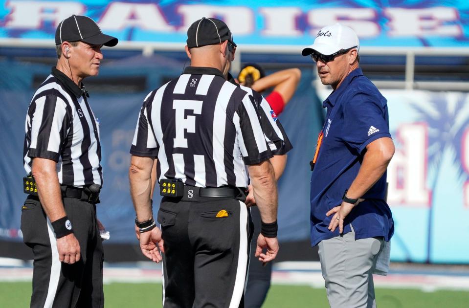 Florida Atlantic head coach Tom Herman talks with the officials before a 42-20 victory over Monmouth at FAU Stadium on Saturday, September 2, 2023, in Boca Raton, FL.