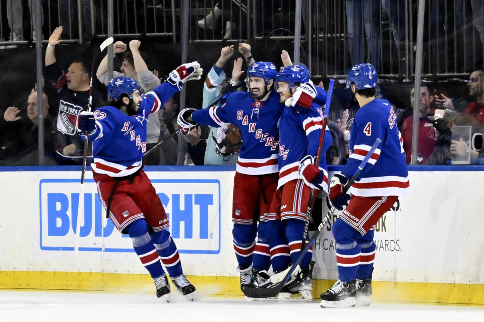 New York Rangers center Jack Roslovic (96) celebrates his goal with Mika Zibanejad (93), Chris Kreider (20) and Braden Schneider (4) during the first period of an NHL hockey game against the Ottawa Senators Monday, April 15, 2024, at Madison Square Garden in New York. (AP Photo/Bill Kostroun)