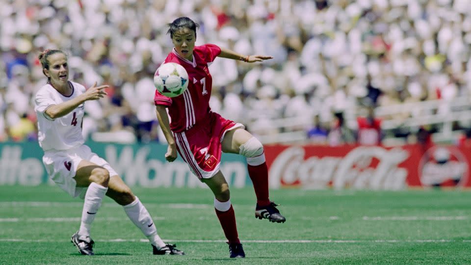 China's Zhang Ouying and Carla Overbeck for America compete during the final of the 1999 World Cup at the Rose Bowl in Pasadena, California. - Vincent Laforet/Hulton Archive/Getty Images