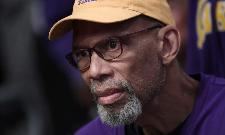 Former Lakers great Kareem Abdul-Jabbar looks on.